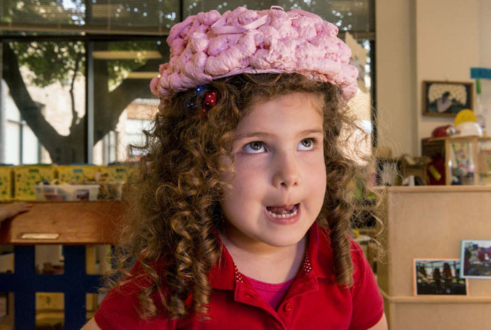 Momentous Institute pre-k student Victoria Menendez wears a brain hat made of packing peanuts. Every student in the school learns the three main parts of his or her brain before kindergarten. Photo by Danny Fulgencio 