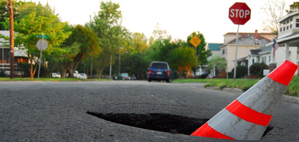 pothole with caution cone Getty