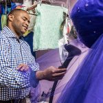 U.S. Rep. Marc Veasey steams a dress at Veronica’s, a quinceañera and wedding shop on Jefferson Boulevard, as part of his pledge to spend time in his constituents’ work shoes. (Photo by Danny Fulgencio)