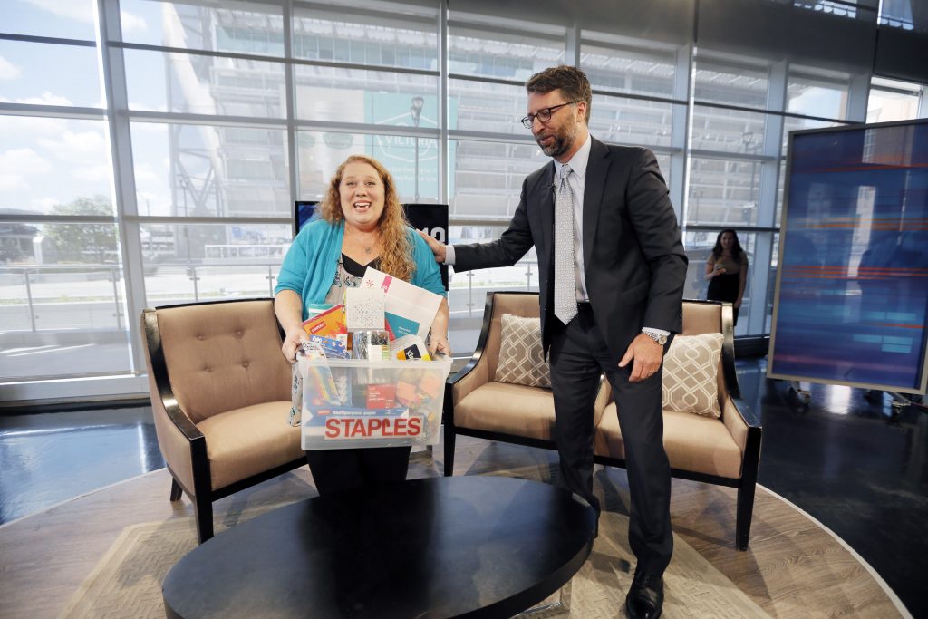 Jennifer Hatcher of Greiner middle school receives a surprise live on WFAA Tuesday morning from Staples vice president of global communications Bill Durling. Photo by Brandon Wade/AP Images for Staples
