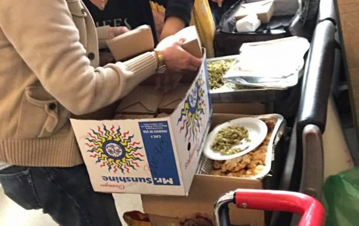 Chef Anastacia Quinones of Oddfellows delivers food to protestors at DFW airport. (Photo by Michelle Meals)