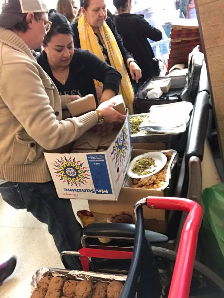 Chef Anastacia Quinones of Oddfellows delivers food to protestors at DFW airport. (Photo by Michelle Meals)