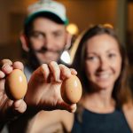 Sam and Amy Roberts with organic eggs from a local farm.(Photo by Kathy Tran)