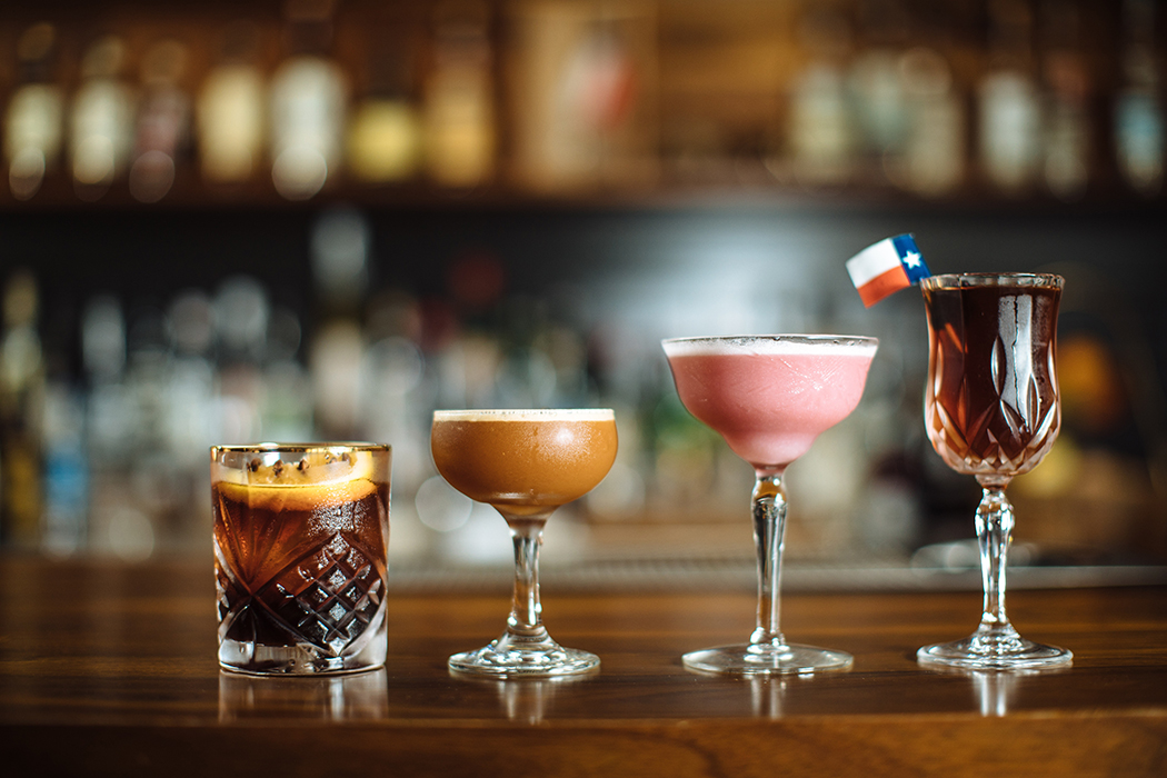 A lineup of artfully crafted cocktails: One of these nights, two-lane blacktop, pink lady and Manhattan Texas. (Photo by Kathy Tran)
