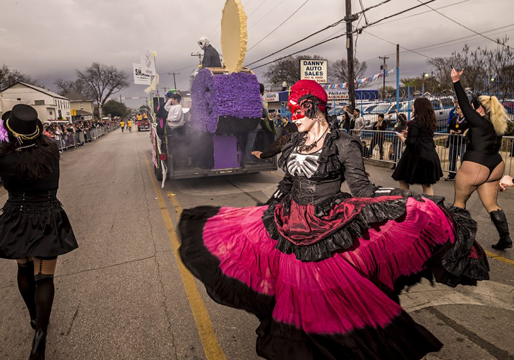 A Mardi Gras dancer twirls down West Davis during the annual Oak Cliff Mardi Gras parade in February. The parade draws thousands of people to the neighborhood and is one of the biggest events in Oak Cliff. (Photo by Danny Fulgencio)