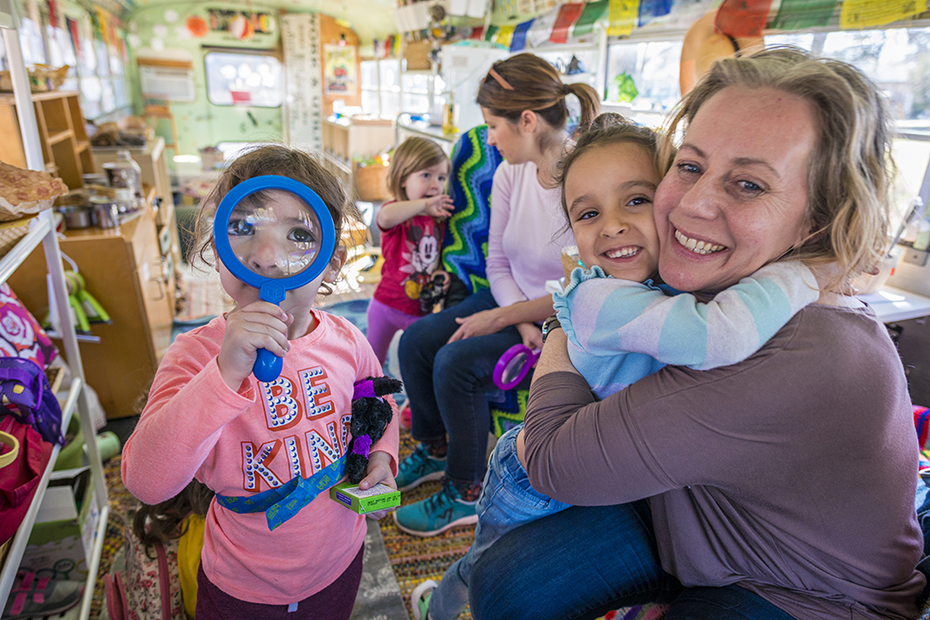 Seed Preschool teacher and owner Jennifer Stuart works with students on her moveable classrooom, a bus named Matilda. Photo by Danny Fulgencio