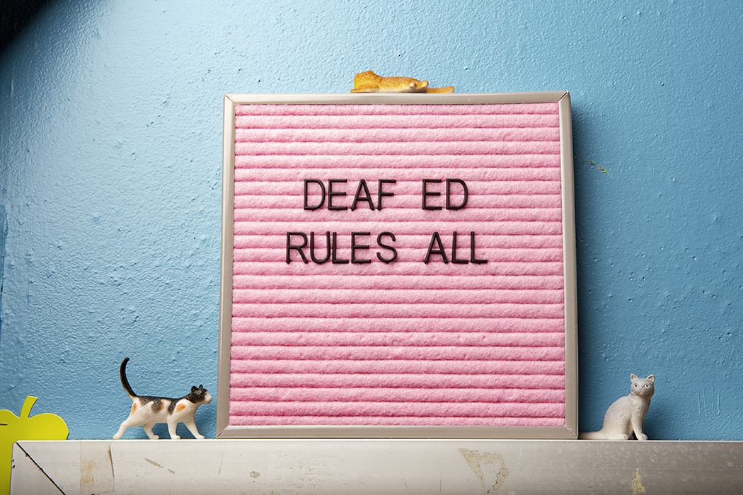 Sign in classroom that reads "Deaf Ed Rules All"