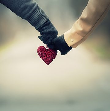 Couple in love holding hearts.