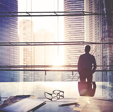 Looking out an office building at sunset. Getty image