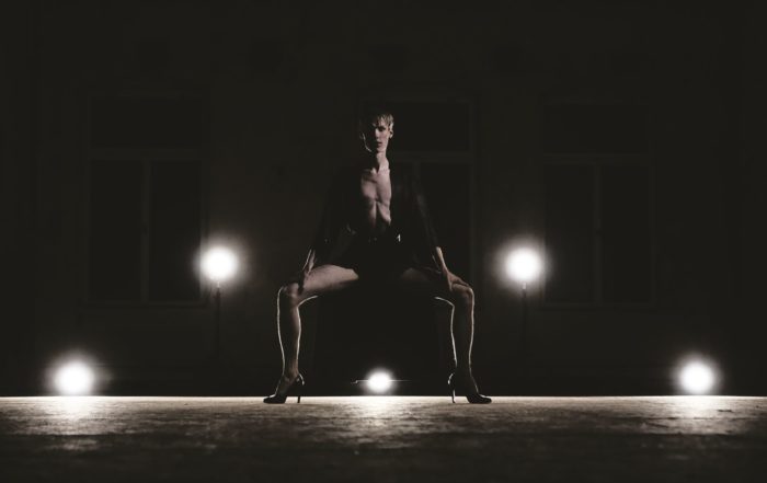 A dancer in a low plié squat.