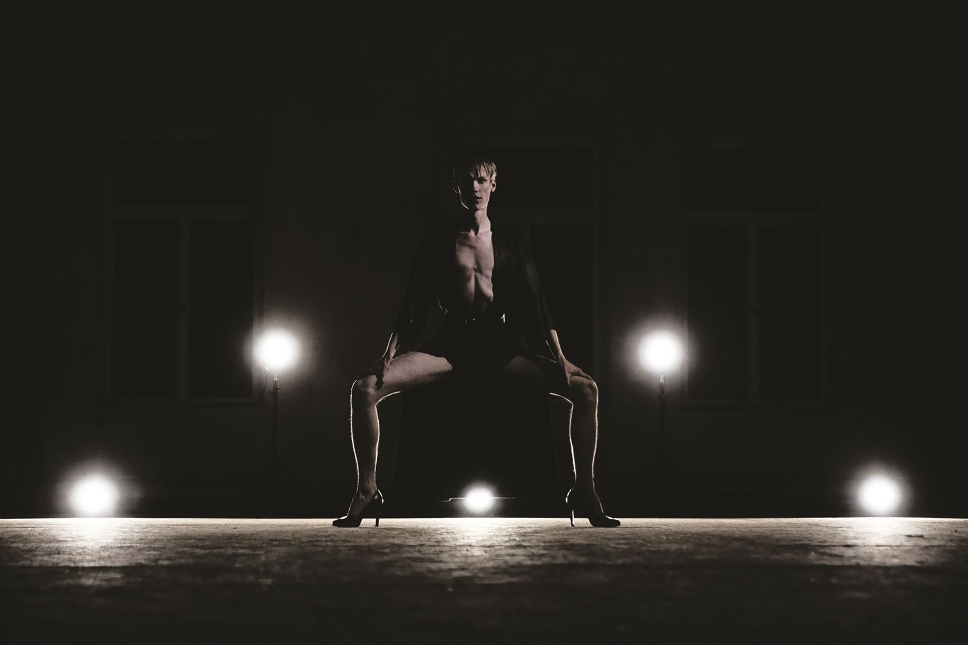 A dancer in a low plié squat.