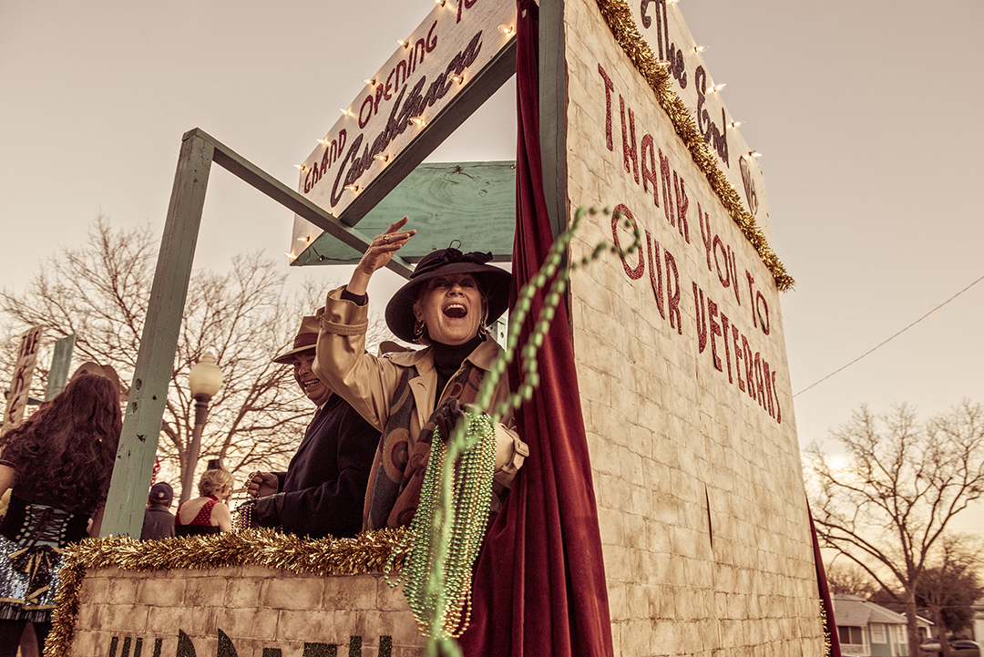 Mardi Gra parade float in Oak Cliff with woman throwing beads. Photo by Danny Fulgencio