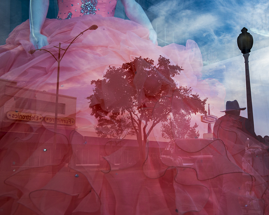 Pink quinceañera dress in the windo with reflection of Jefferson Boulevard. Photo by Danny Fulgencio 