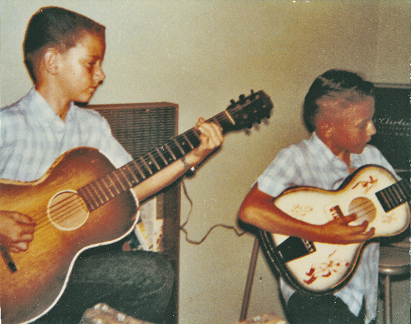Stevie Ray and Jimmie Vaughan grade school age playing guitar together.
