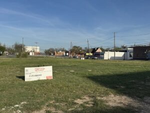 A five-story apartment complex could fill an empty lot on West Davis Street